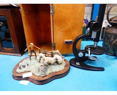 A 20th Century student microscope in a box and a Border Fine Arts sheep gathering model (A/F)