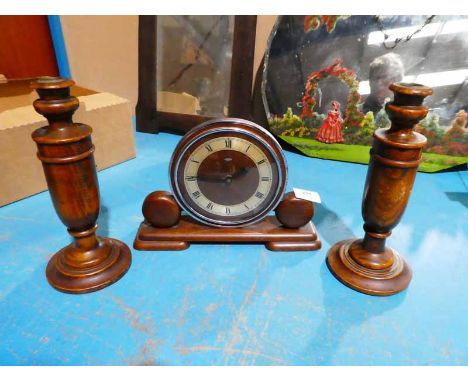 An Art Deco oak mantle clock garniture incorporating a pair of turned column candlesticks  