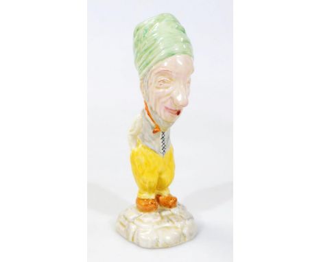 A 20thC pottery figure of a bearded gentleman, in a standing pose, polychrome decorated predominantly in yellow, green and or
