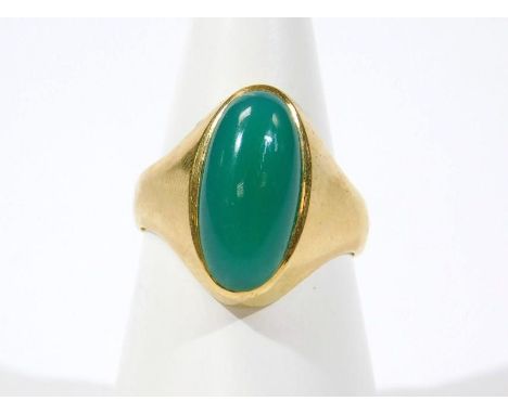 A jade set dress ring, the central oblong stone in rub over setting, yellow metal, marked 750, 5.8g all in. 