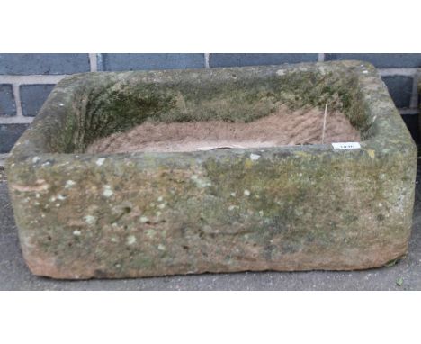 An early 20thC stone trough, of rounded rectangular outline, the centre set with plug hole, 22cm high, 59cm wide, 41cm deep.