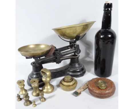 A black glass bottle, of shouldered outline with corked top and inverted base, 31cm high, a set of Labrasco scales with dumb 