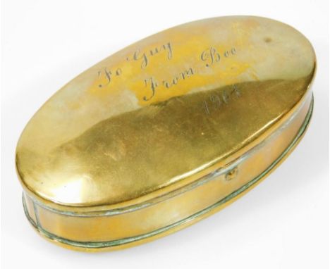 An Edwardian brass snuff box, of oval outline, the hinged lid reading 'To Guy from Boom' 1901, 12cm wide.