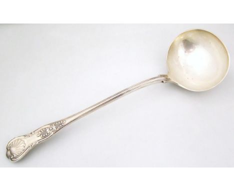 A Victorian silver serving ladle, shell capped Fiddleback pattern with plain oval shell capped bowl, London 1891, 33cm wide, 