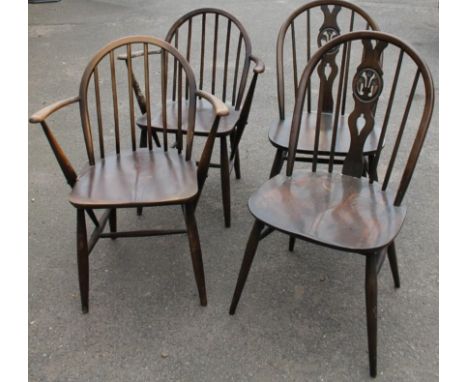 A set of four Ercol ash, beech and elm dining chairs, each with a spindle turned back, and solid seat, on turned tapering leg