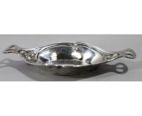 An Edwardian silver later Art Nouveau design bowl, with pierced handles, the shaped body raised with flowers on an oval foot,