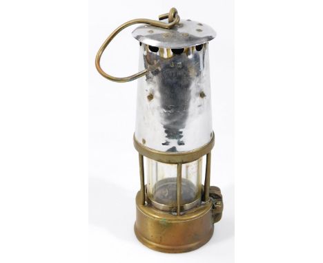 A mid 20thC miner's lamp, in chrome colour and brass, of cylindrical outline, with central glass section and hook handle (the