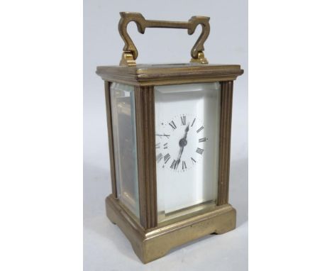 An early 20thC brass cased miniature carriage clock, with articulated handle, rectangular body, 3.5cm wide back plate with Ro