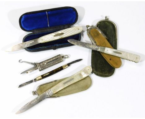 An early 20thC articulated darning aid, with push up buttons revealing some tools with side button hook, set with a hook top,