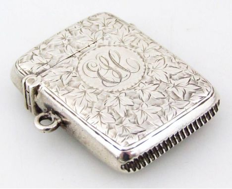 A Victorian silver miniature vesta case, of rounded outline, heavily engine turned centred with initials, with match strike b