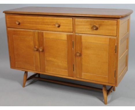An Ercol type light elm antique sideboard, with a shaped moulded top, above an arrangement of one short and one long drawer, 