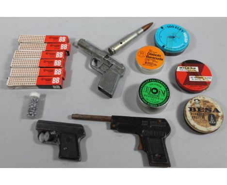 A child's Chad Valley bugle style pistol, 20cm wide, bullet, water pistol, various slugs, etc. (a quantity) 