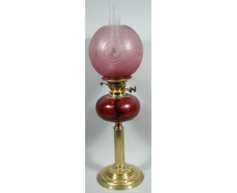 A late Victorian ruby frosted and clear glass and brass oil lamp, with frosted shade set with side profiles of ladies, scroll