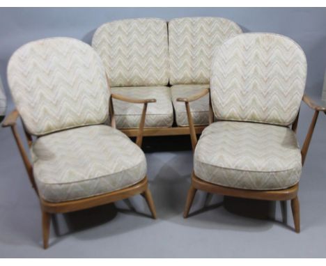 An Ercol three piece cottage suite, with spindle turned back, webbed seat, with loose cushions. 