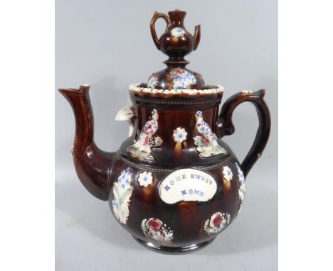 A late 19thC bargeware pottery teapot, the domed lid surmounted by a miniature teapot knop, with thumb mould handle, shaped s