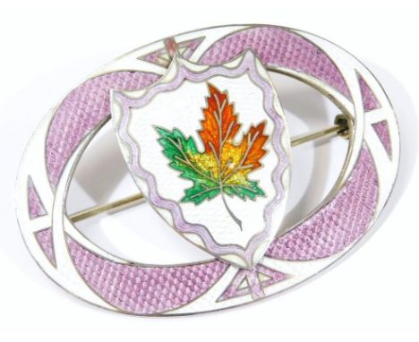 An Arts & Crafts style guilloche enamel brooch, with white and lilac oval border in central shield shape, with autumn coloure