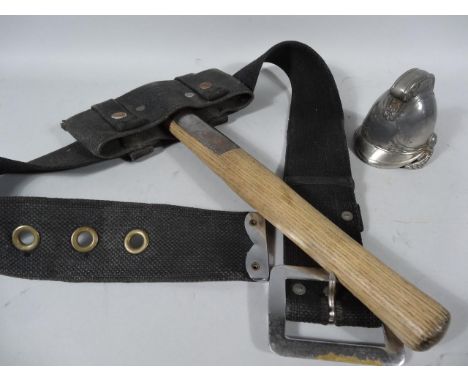 An early 20thC fireman's axe, 40cm high, in leather holster with chrome mounts, and a base metal ink stand in the form of a f