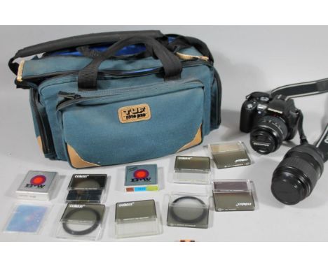 A camera bag, containing various equipment, Olympus E500 camera body, Olympus 40/150 lens and a digital lens 17-5-45. (a quan