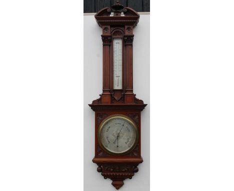A late Victorian walnut aneroid barometer, by Negaritti and Zambra, London, the architectural case with a swan neck pediment,