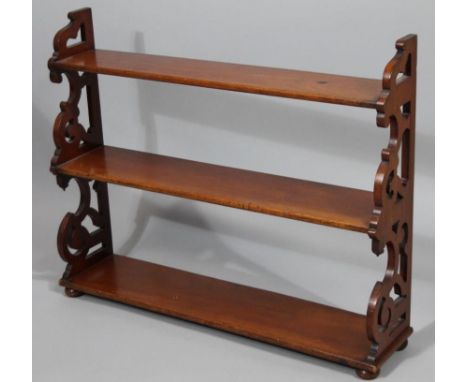 A late 19thC mahogany open wall shelf, with pierced sides, and graduated shelves, 74cm wide. 