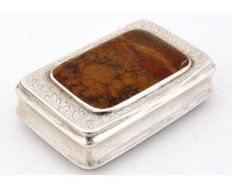 A George III silver snuff box, of oblong outline, centred with a polished section of metamorphic stone, partially engine turn