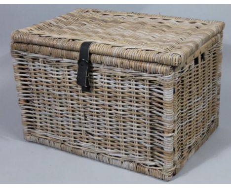 A rattan hamper, with leather fitted interior, 71cm wide. 