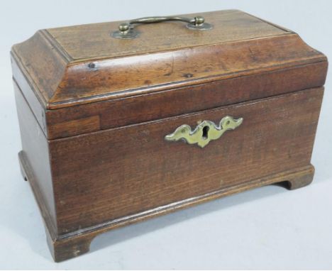 A George III mahogany tea caddy, the rectangular domed lid hinging to reveal a sectional part foil lined interior, with front