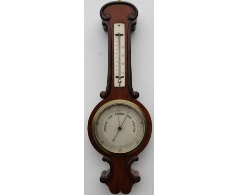 A late 19thC aneroid barometer, in a rosewood case, with ivorine thermometer, and silvered dial, 58cm high. 