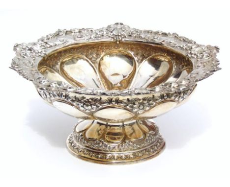 An Edwardian silver footed bowl, by the Atkin Brothers, heavily repoussé decorated to the rim with shaped flower heads, wheat