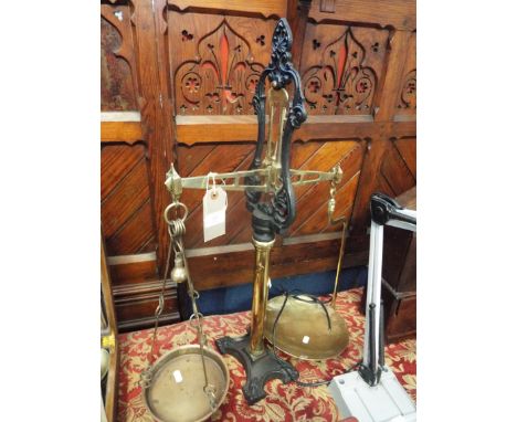 A set of ornate cast iron and brass balance scales