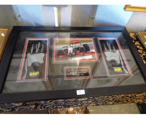 A framed and glazed pair of Formula One racing gloves signed by Lewis Hamilton with photograph and plaque