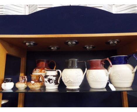 A selection of early jugs decorated with hunting, toper and classical scenes 