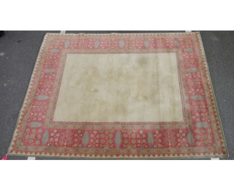 Large wool carpet&nbsp;of revived Eastern style, having stiff leaf and floral spray iron red border and plain ivory field, 30