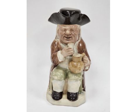 Late 18th century Ralph Wood-type creamware toby jug and cover, modelled seated holding a mug of ale and a beaker, enriched i