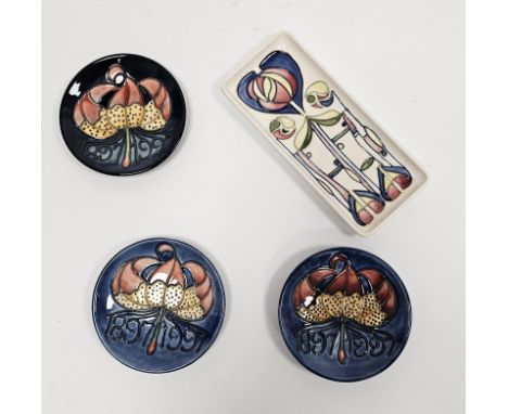 Three Moorcroft commemorative small circular Centenary dishes, boxed, each tube-lined with date 1897-1997 with lily flower ab