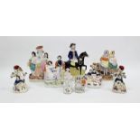 Collection of Victorian pottery flatback figures including a group of Queen Victoria and Prince