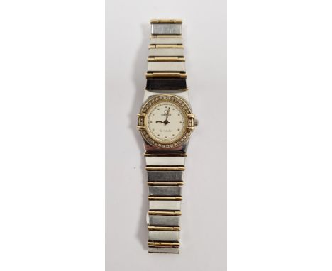 Lady's Omega Constellation wristwatch, gold and stainless steel, the circular dial with raised dot hour markers, a diamond se