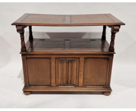 Reproduction carved oak monk's bench&nbsp;with linenfold panelling to the hinged table-top/seat back, having scroll arms and 