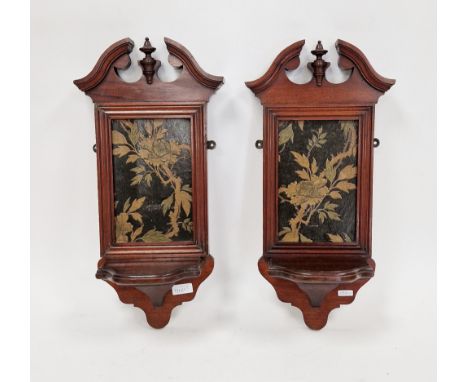 Pair late Victorian/Edwardian mahogany wall brackets, each with broken swan neck pediment, inset with embossed floral panel, 