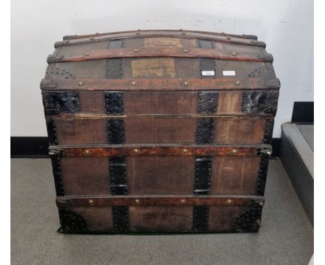 Late 19th century Finnigans dome-topped wooden bound trunk&nbsp;opening to reveal a fitted interior, 63cm high x 70cm wide x 