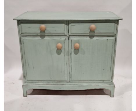 Vintage sage green distressed painted kitchen cupboard, with two frieze drawers above two panelled cupboard doors enclosing a