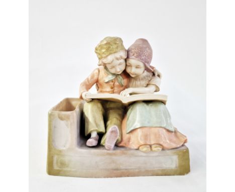 Early 20th century Vienna (Amphora) ceramic figure group&nbsp;of two Dutch-style children embracing, reading a book, with cyl