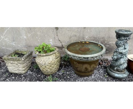 A reconstituted stone bird bath on a twisting tree and fruit column together with two reconstituted stone planters and a ston