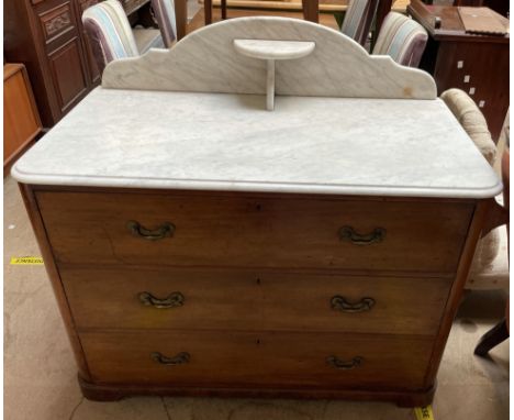 A Victorian marble topped mahogany wash stand / chest, the marble top with a raised back and shelf above three long drawers o