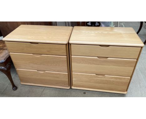 A pair of light oak veneered chests, the rectangular top above three drawers approximately 70cm high x 67cm wide x 39cm deep