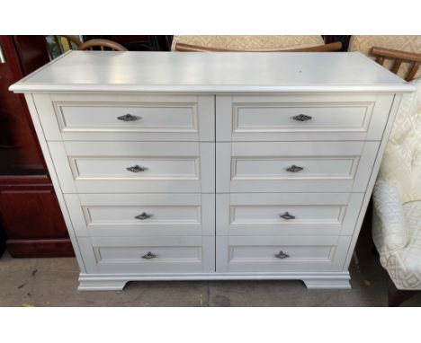 A modern chest, in cream, the rectangular moulded top above eight drawers on bracket feet