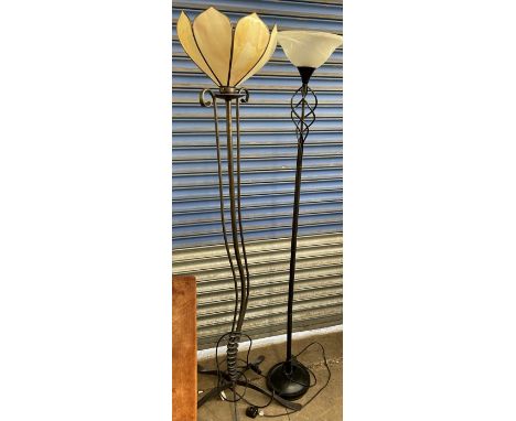 A wrought iron standard lamp with a leaf shaped glass shade and a flowing base together with a metal and glass uplighter