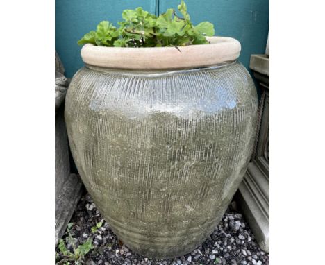 A large green glazed stoneware planter