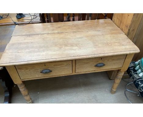 A Victorian pine desk, the rectangular planked top above two drawers on ring turned tapering legs