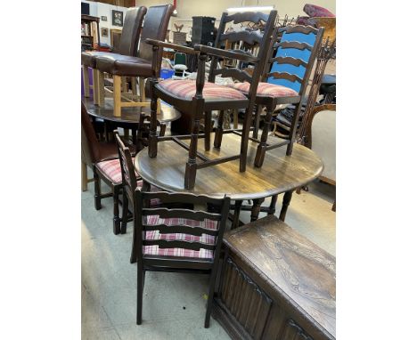 A modern gateleg dining table together with a set of six ladder back dining chairs